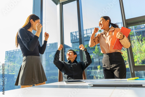 Business people having a meeting in the office. Businessman and businesswoman are celebrating success.
