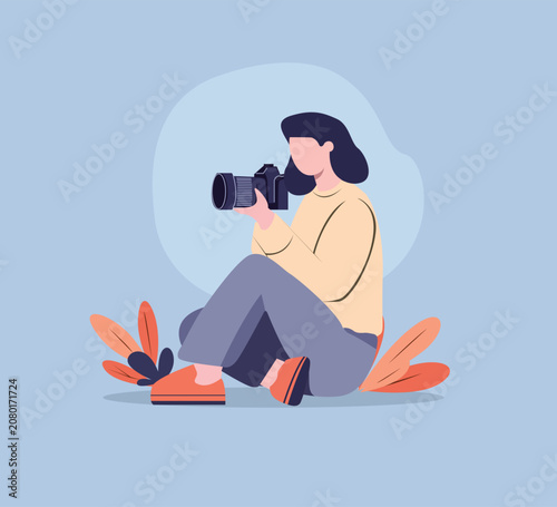 Photographer sitting with camera Vector illustration in a flat style