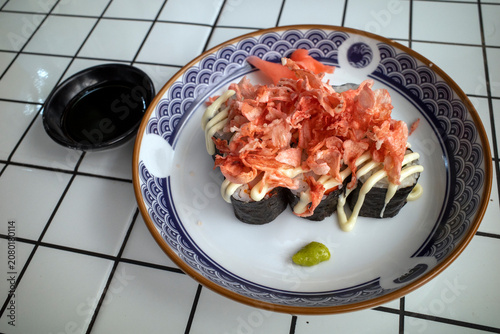 Homemade beef shusi on a porcelain plate & a ceramic table