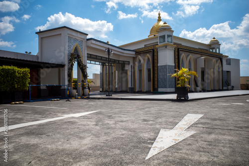 Kubah Masjid. A mosque with a beautiful yellow dome in Yogyakarta, Indonesia with blue sky background