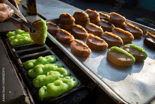 The making process of Kue Pukis, a traditional Javanese  pancakes on street food market, in Yogyakarta, Indonesia