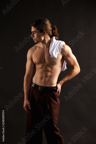 Принти на полотні Intense Gaze of a Muscular Man With Towel Draped Over Shoulder