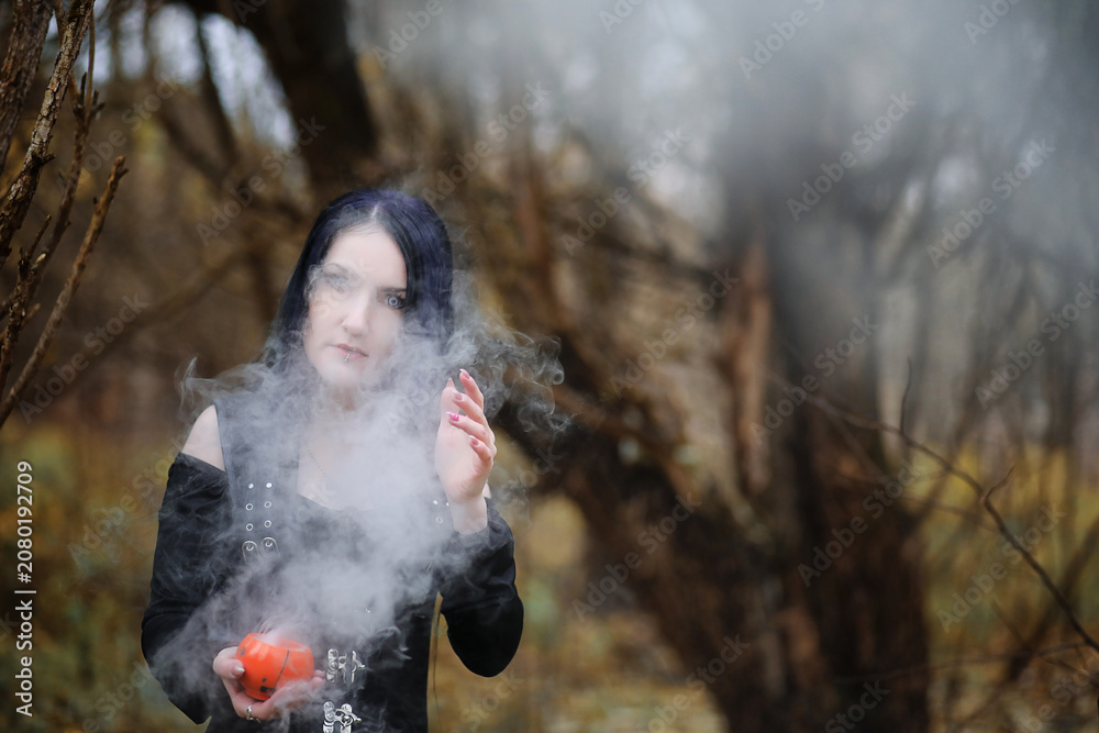 Obraz premium A woman in a witch suit in a forest
