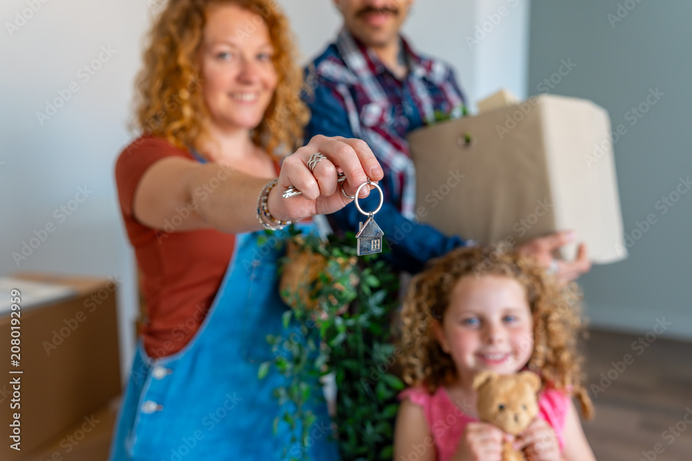 Fototapeta premium Family receiving house keys moving into new home