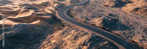 Winding asphalt road through desert sand dunes and rocky mountains aerial view banner