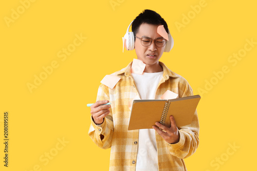 Confused young Asian man wi...