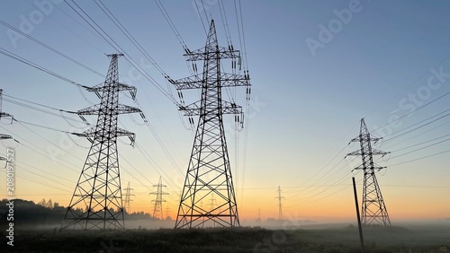 Obraz na plátně High voltage power transmission lines at sunrise with morning fog, electricity p