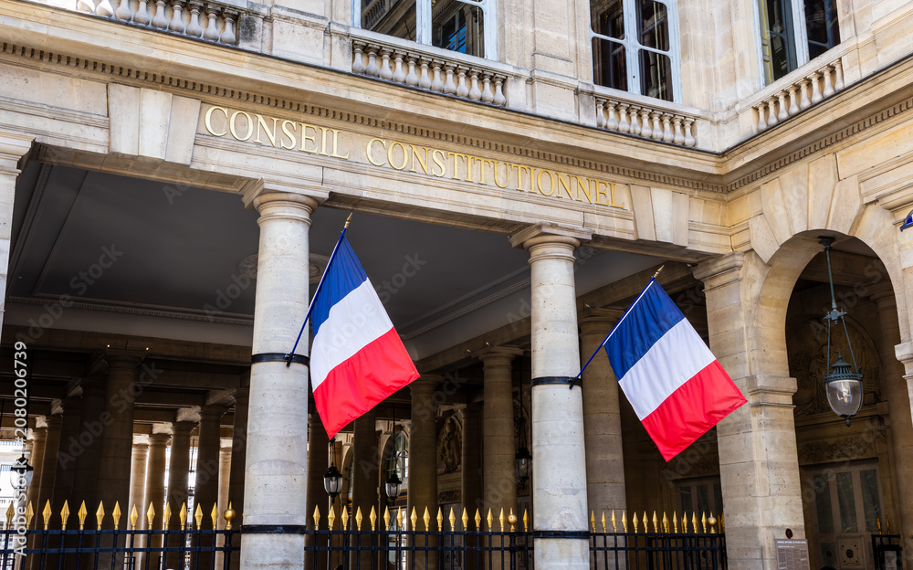 Obraz premium Paris, France - June 17, 2026: Portico decked with french flags at the entrance of the Constitutional Council, the highest constitutional authority in France, located in the Palais Royal.