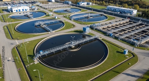 Aerial View of a Large Wastewater Treatment Plant Showing Circular Settling Tanks and Infrastructure
