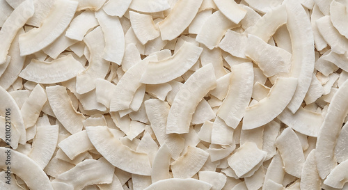 Close up full frame texture of raw unsweetened coconut flakes