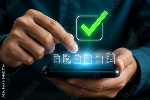 Man's hand touching phone screen with digital checklist icons and green checkmark during virtual approval process