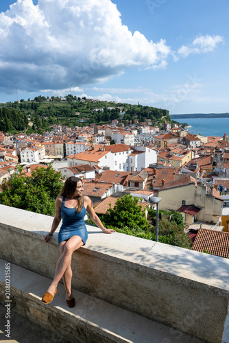 Photography Woman enjoying panoramic views of Piran old town and the Adriatic coast during a