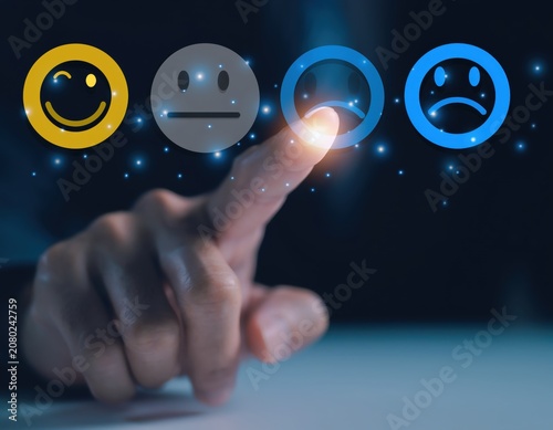 Customer experience concept with finger touching a dissatisfied emoji icon
