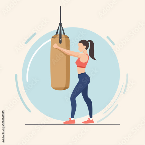 Woman punching a boxing bag during a fitness workout