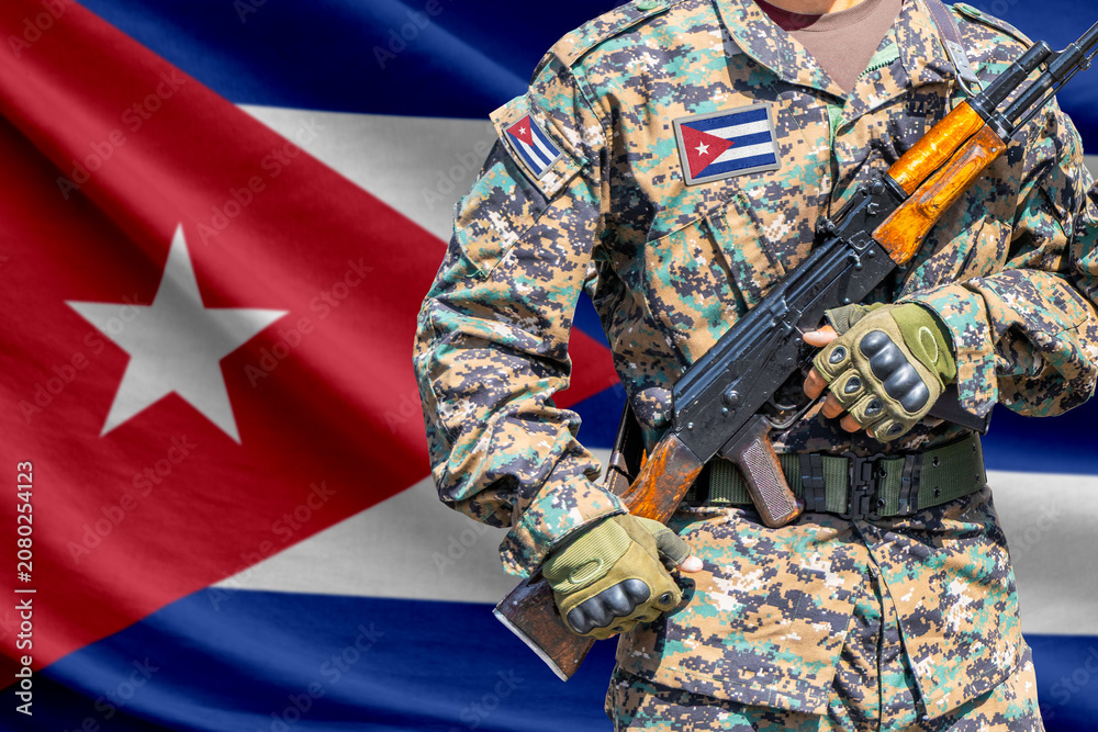 Fototapeta premium Cuba flag with soldier holding assault rifle