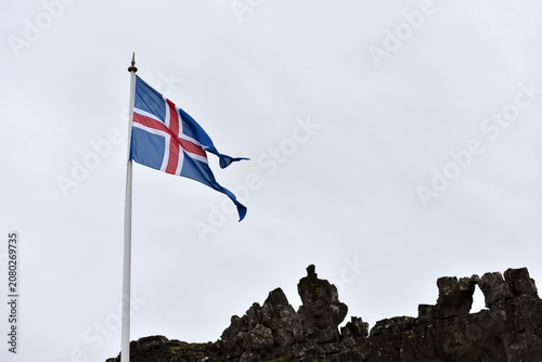 Canvas Print National flag of Iceland against a cloudy sky