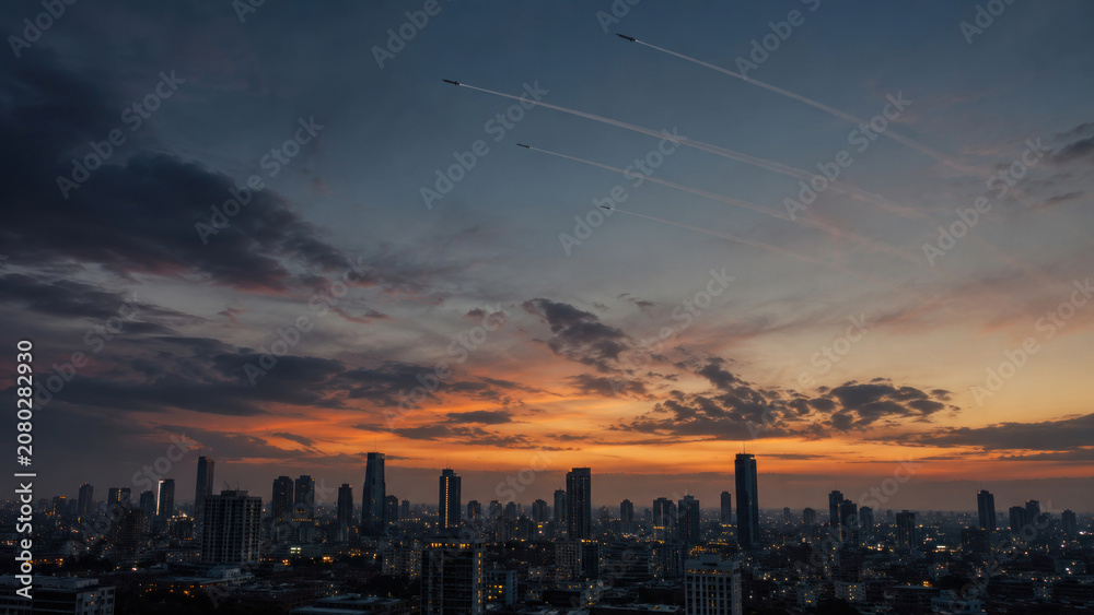 Fototapeta premium Military Jets Flying in Formation Over City Skyline at Sunset