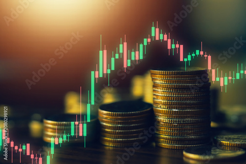 Close up of stacked coins with glowing candlestick chart highlighting financial investment, trading strategy, market analysis, business growth, wealth creation and economic opportunity.