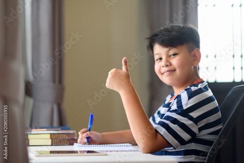 Fotografie Successful student showing thumbs gesture celebrating academic achievement maste