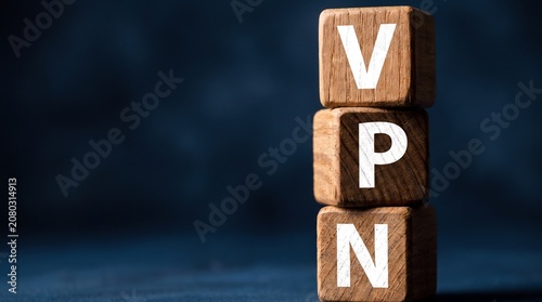VPN acronym written on stacked wooden blocks for Virtual Private Network, internet security, and data privacy concept on dark background.