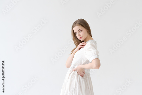 Obraz na plátně Romantic Young Woman in a White Cotton Dress Soft Feminine Portrait