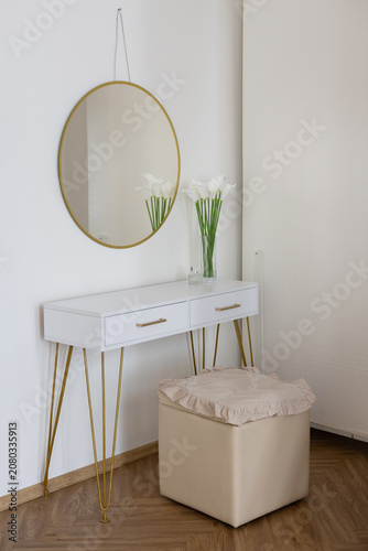Makeup corner in the apartment, a woman's vanity table in light tones. Vertical image