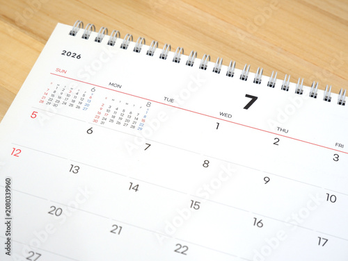 2026 calendar, July 2026 desk calendar placed on a wooden desk, 2026 New Year's resolutions.