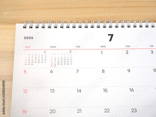 2026 calendar, July 2026 desk calendar placed on a wooden desk, 2026 New Year's resolutions.