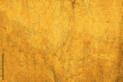 Rough textured mustard yellow stained paper background, suitable for vintage design projects, scrapbooking, backgrounds, and textures for print and digital.