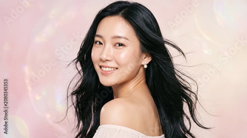Beautiful Asian Woman Smiling on Pink Background Youthful Beauty and Natural Elegance