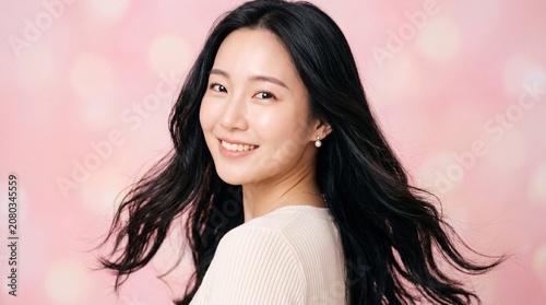 Beautiful Asian Woman Smiling on Pink Background Youthful Beauty and Natural Elegance