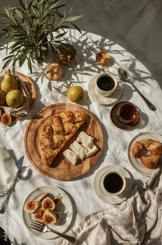 Table Set With Bread, Fruits, Tea, and Coffee During Morning Time