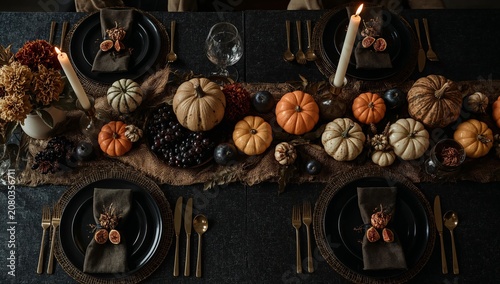 Table Setting for a Fall Feast With Pumpkins and Candles in a Cozy Indoor Space