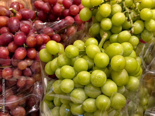 Cuadro en lienzo Fresh green and red grapes at market