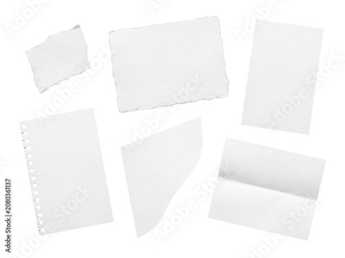 Assortment of blank white paper pieces with varied textures, torn edges, and folded elements.