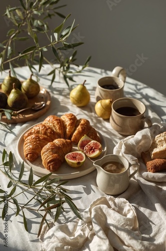Breakfast Spread With Croissants, Figs, Coffee, and Pears on a Table