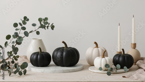 Decorative Pumpkins and Candles Arranged on a Table With Green Leaves in a Si...