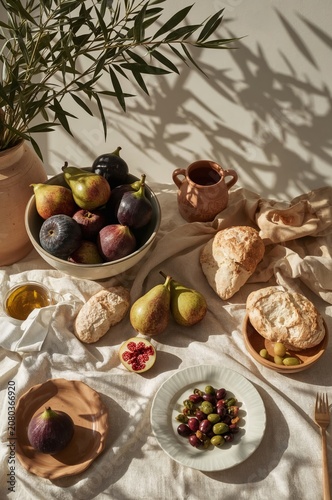Food Arrangement on a Table With Fruits, Bread, and Small Dishes in a Bright ...