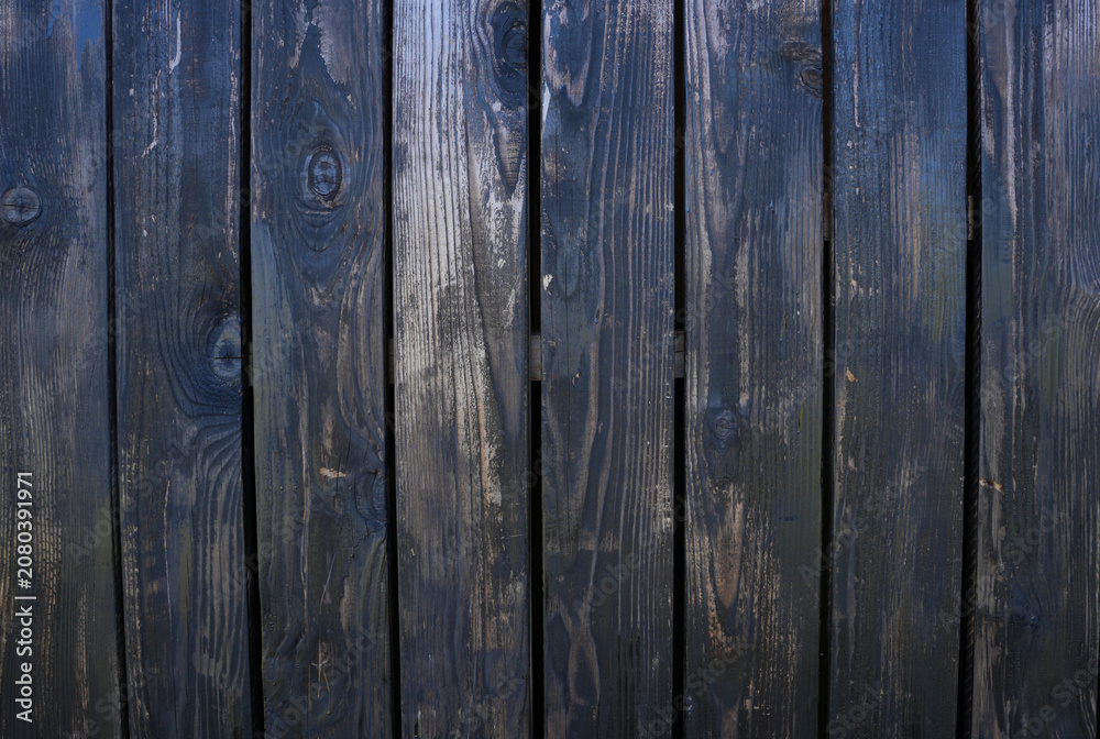 Fototapeta premium Weathered dark blue and black vertical wooden boards texture. Great backdrop for text overlays, digital mockups, and graphic design projects.