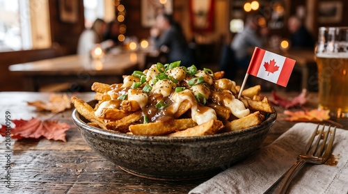 Delicious poutine with cheese curds and gravy, garnished with a Canadian flag, served on a rustic wooden table with autumn leaves and a glass of beer in a cozy restaurant.