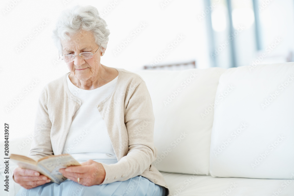 Obraz premium Relax, book or old woman on sofa with reading, fantasy novel or insight in literature hobby. Chill, glasses or senior person in house with fairytale, peaceful moment or fiction story in retirement.