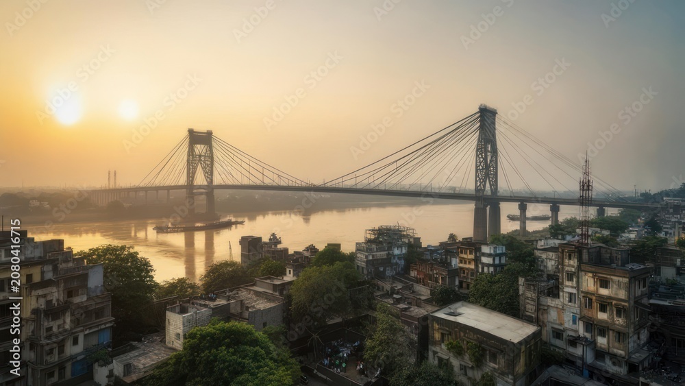 Fototapeta premium Panoramic sunrise over a city and river with a bridge