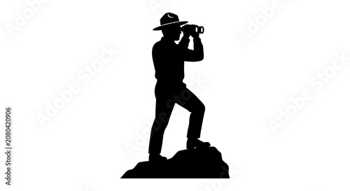 Forest warden observing from rocky outcrop silhouette