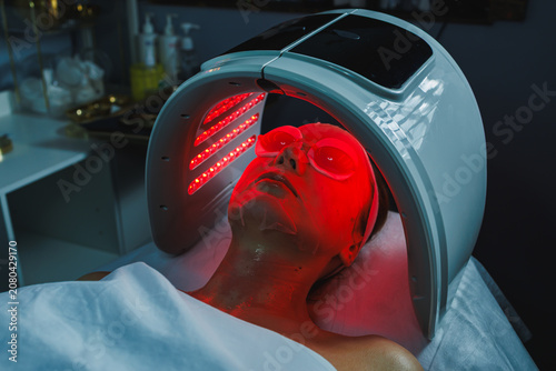 Photos Cosmetology appointment at a beauty salon for a woman receiving light therapy tr