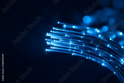 Fiber optic cable data transmission with glowing light for telecommunications and high speed internet technology businesses