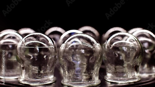 Vintage glass cupping therapy cups rotating close-up, traditional medical equipment
