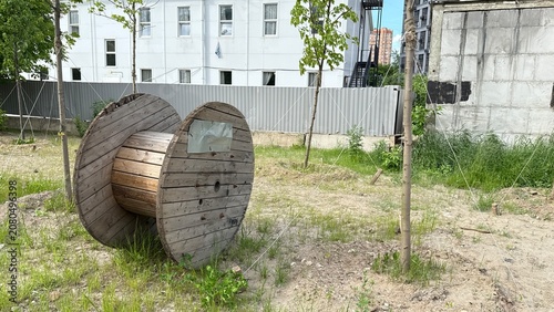 Large empty wooden cable reel placed on construction site ready for infrastructure and utility installation