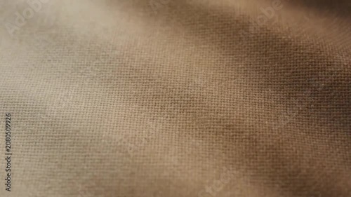 Soft brown linen fabric texture background with gentle folds and waves