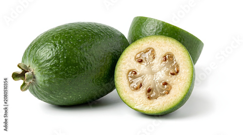 Fresh New Zealand feijoa fruit whole and halved showing juicy center, isolated on a white background