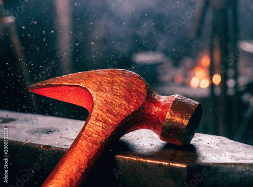 Close-Up of Glowing Molten Metal Hammerhead with Sparks in Forge
